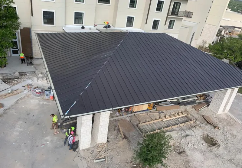 Metal roofing installation team working on a commercial building in Leacock