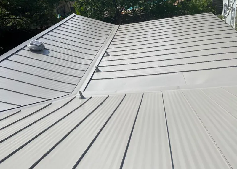 Solar attic fan installed on a metal roof for Roof Ventilation in Leacock
